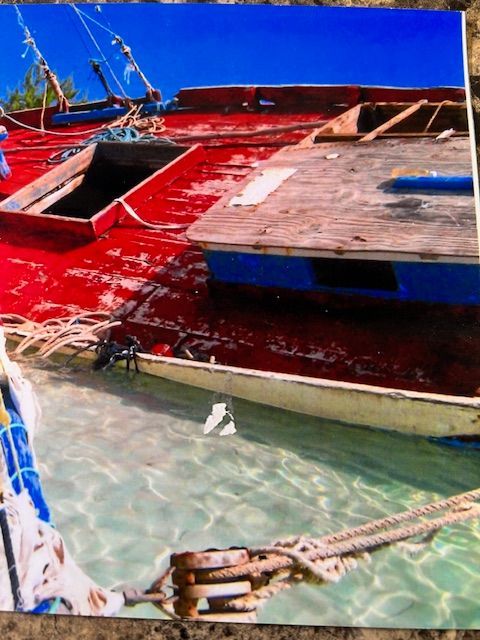 A picture of boats in the water with a blue sky in the background