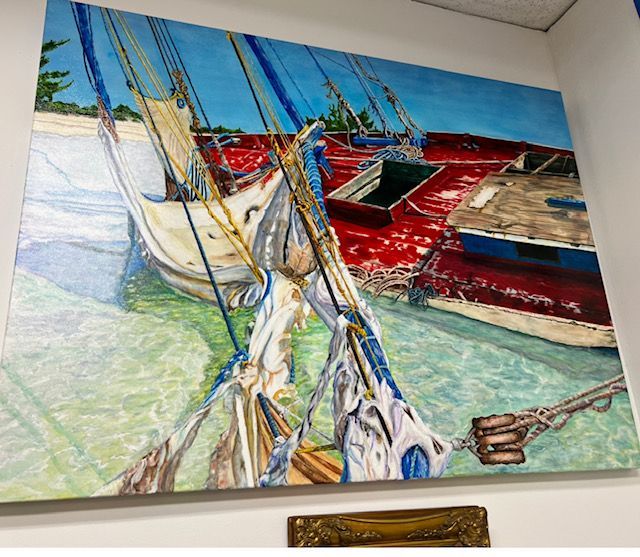 A large painting of boats in the water hanging on a wall