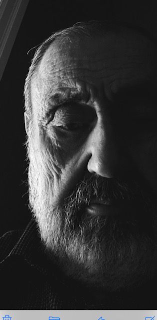 A black and white photo of a man with a beard.