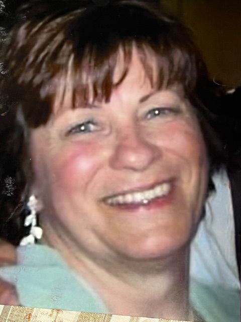 A close up of a woman 's face smiling for the camera.