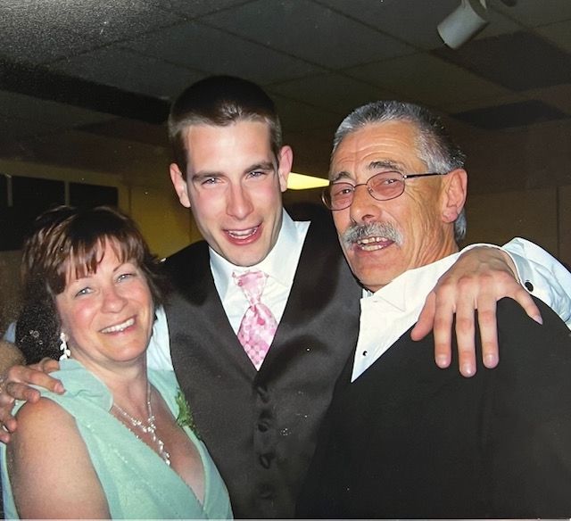 A man and two women pose for a picture together