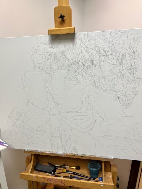 A painting is being painted on an easel in a room