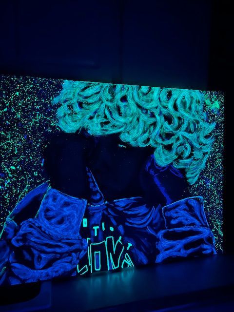 A glow in the dark painting of a clown