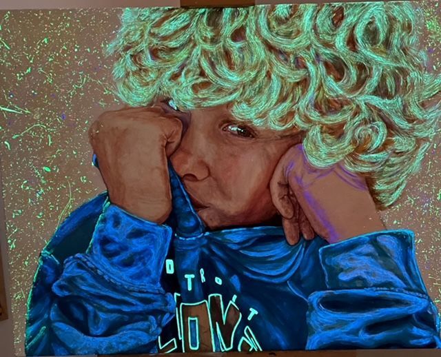 A glow in the dark painting of a boy with curly hair