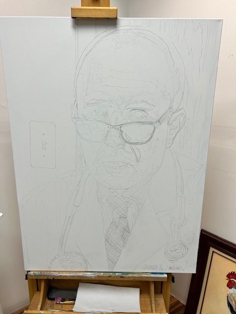 A drawing of a man wearing glasses is on an easel.
