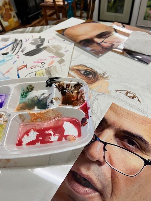 A painting of a man with glasses and a tray of paint