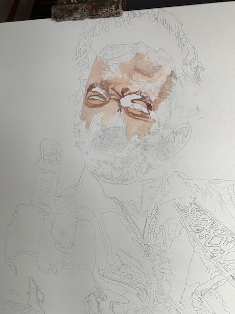 A close up of a drawing of a man 's face on a piece of paper.