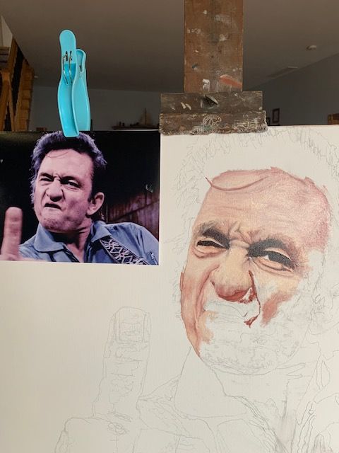 A painting of a man with a beard is being painted