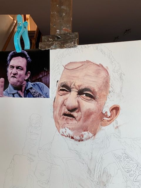 A painting of a man with a beard is being painted