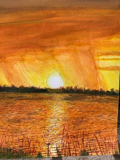 A painting of a sunset over a body of water.