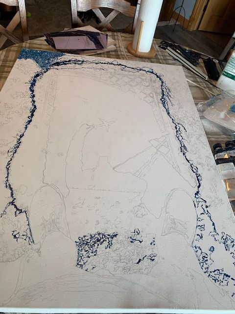 A painting is being painted on a canvas on a table