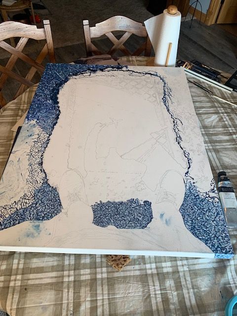 A painting of a man with a beard is being painted on a table.