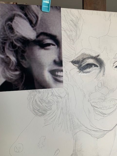 A drawing of marilyn monroe is being worked on