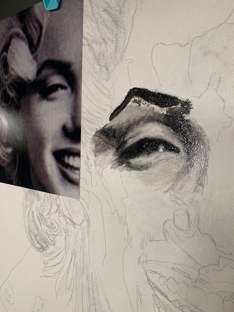 A drawing of a man 's face next to a picture of marilyn monroe