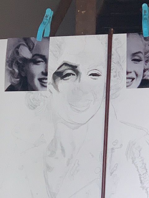 A drawing of marilyn monroe is being worked on