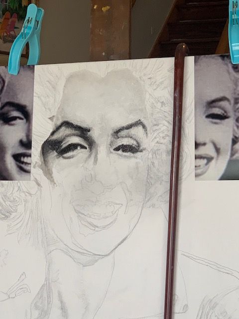 A drawing of marilyn monroe is being worked on