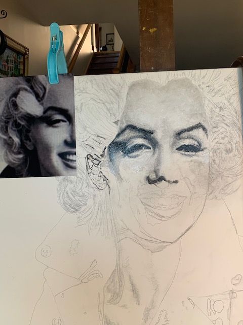 A drawing of marilyn monroe is being worked on