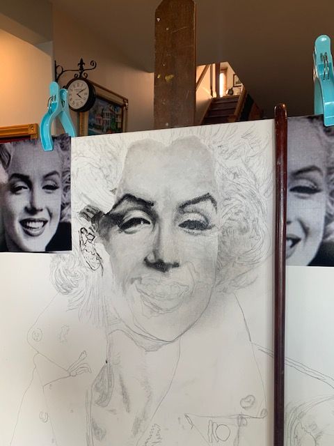 A drawing of marilyn monroe is being worked on