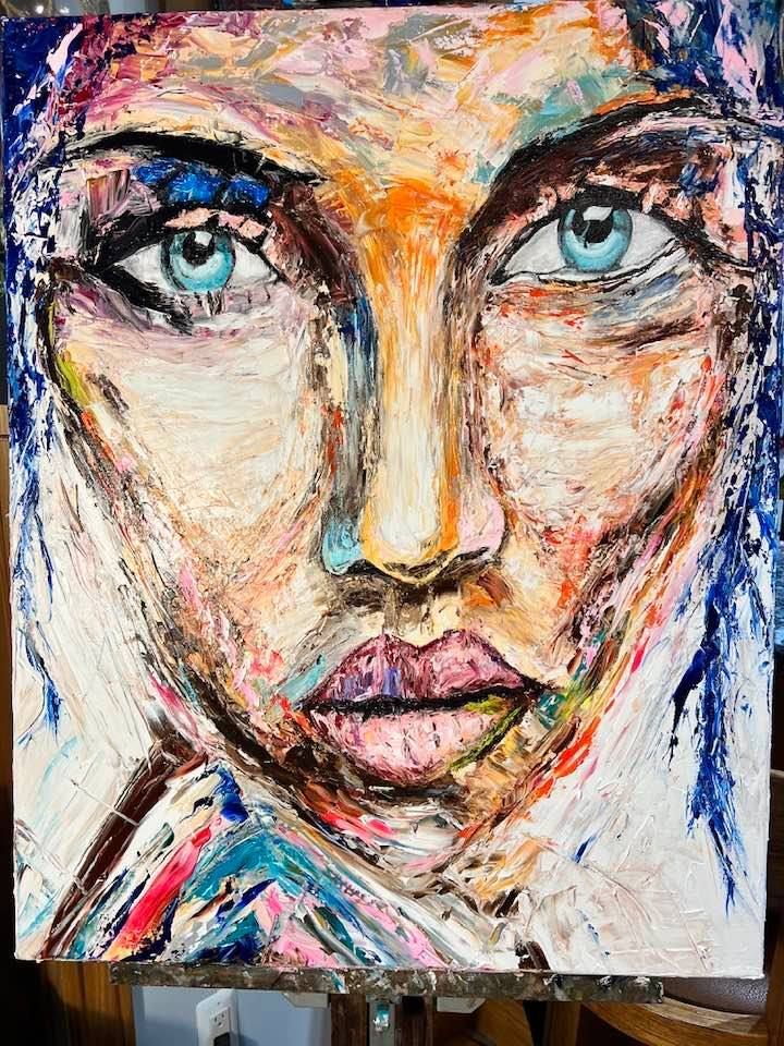 It is a painting of a woman 's face with blue eyes.