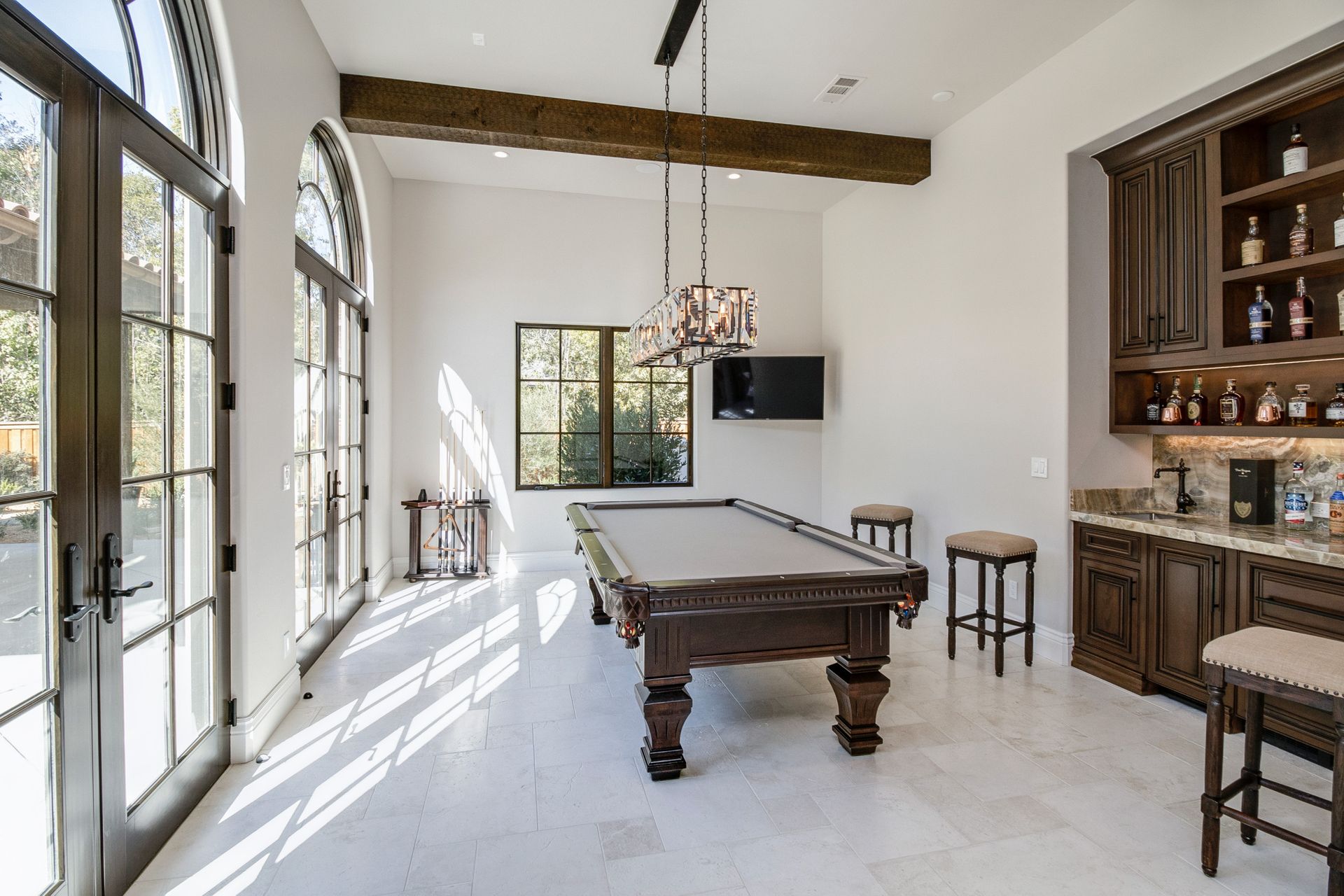 There is a pool table in the middle of the room.