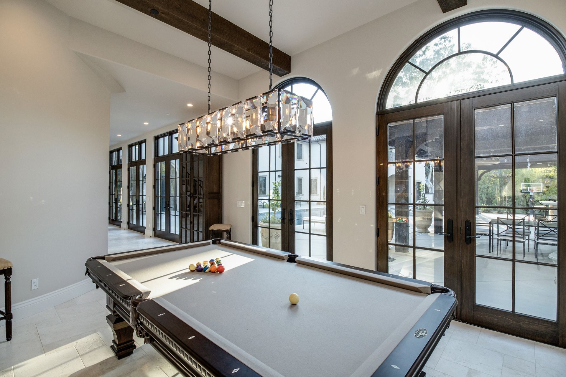 There is a pool table in the middle of the room.