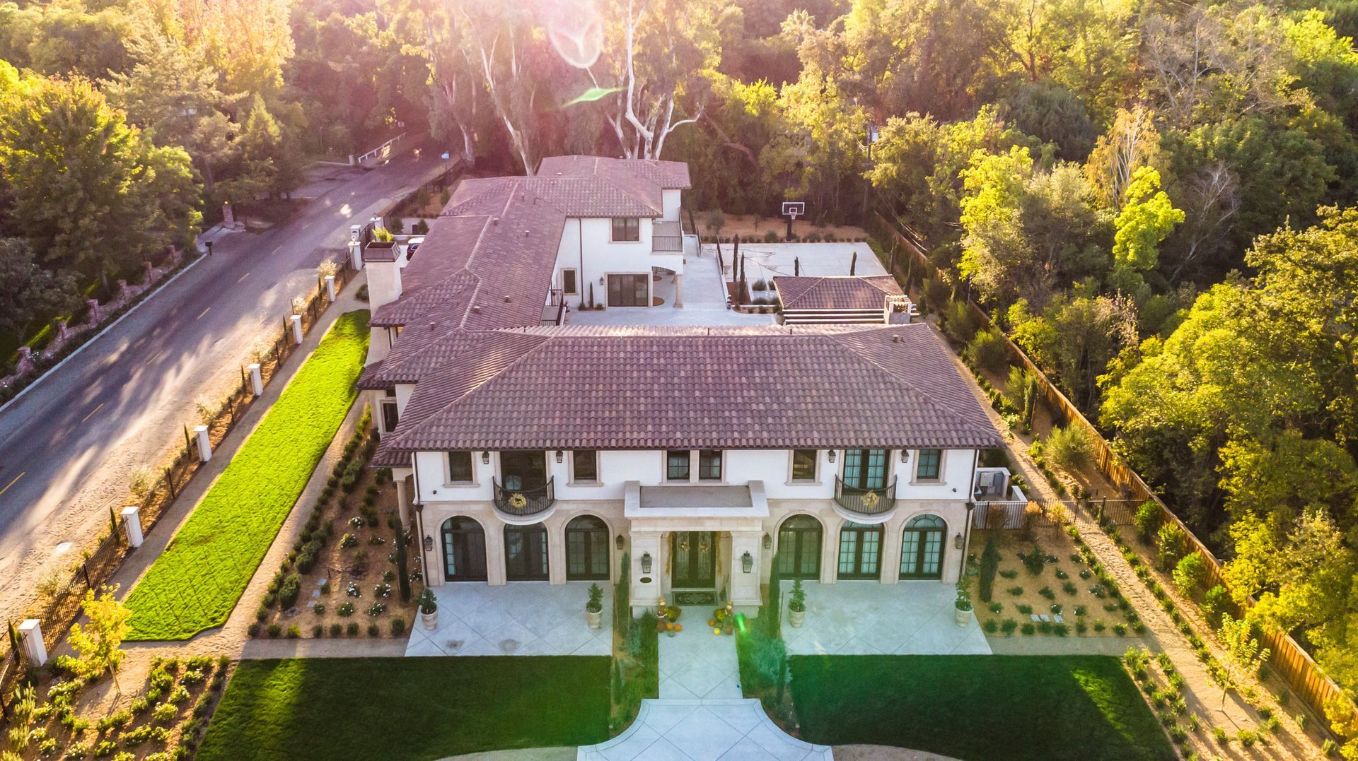 An aerial view of a large house surrounded by trees.