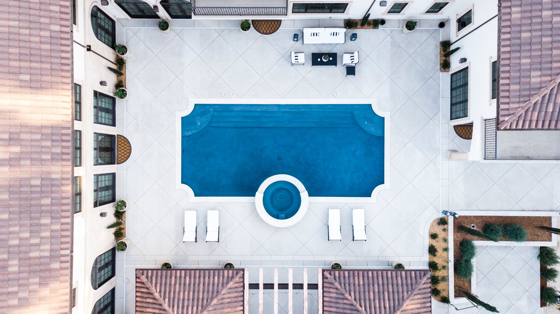 An aerial view of a large swimming pool surrounded by houses.
