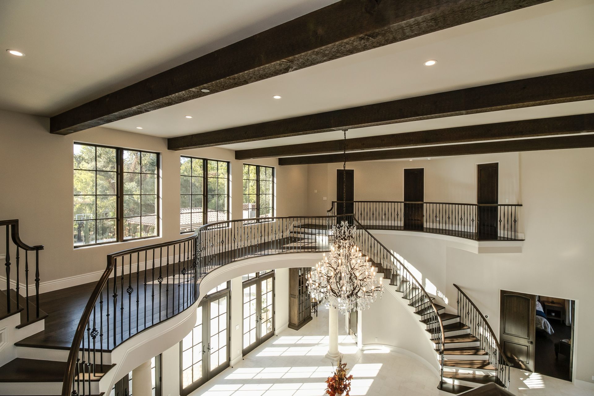 A large room with a staircase and a chandelier
