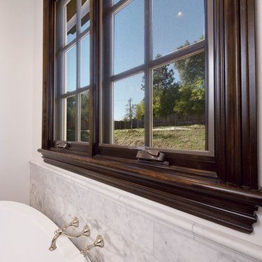 A bathroom with a large window and a bathtub.