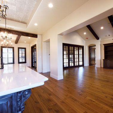 A kitchen with hardwood floors and a white counter top