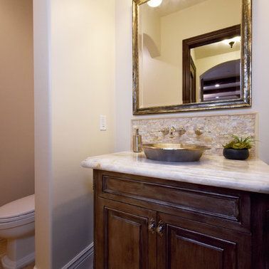 A bathroom with a sink , mirror and toilet.