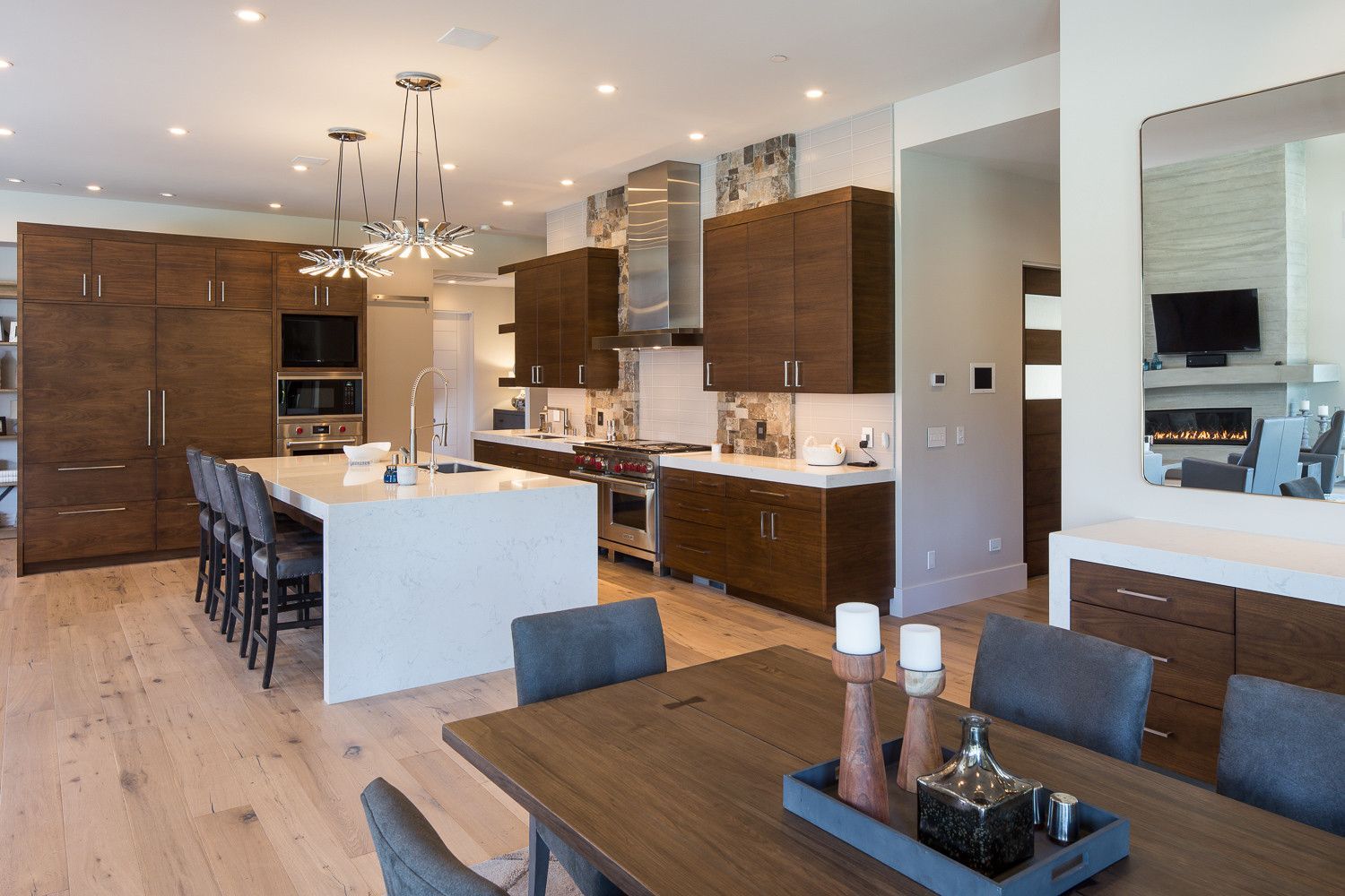 There is a dining table in the middle of the kitchen.