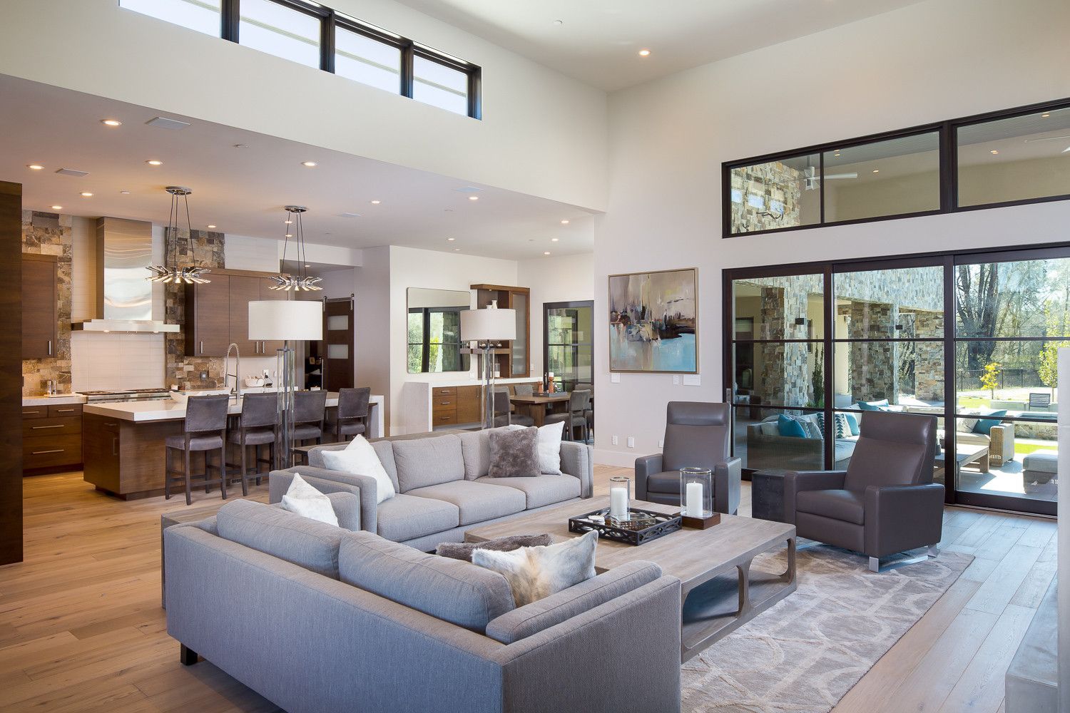 A living room with a couch , chairs , and a table.