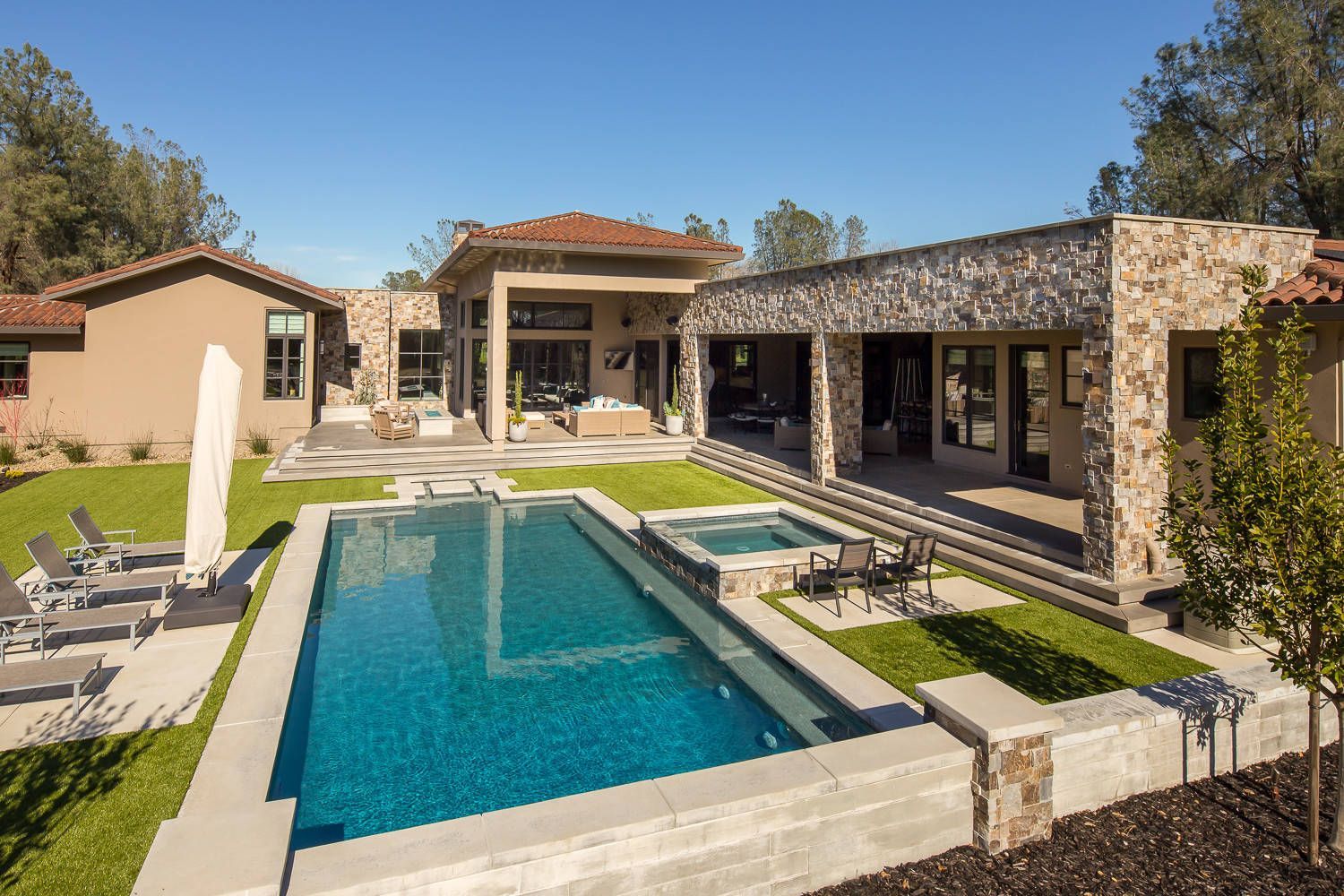 A large house with a large swimming pool in front of it