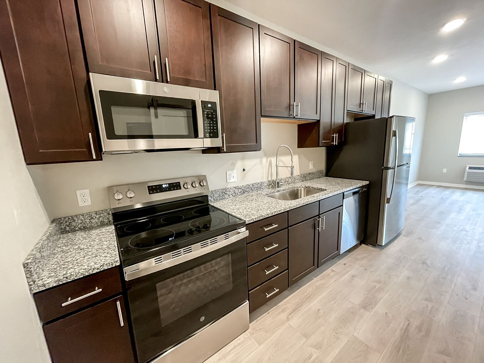 A kitchen with stainless steel appliances and granite counter tops