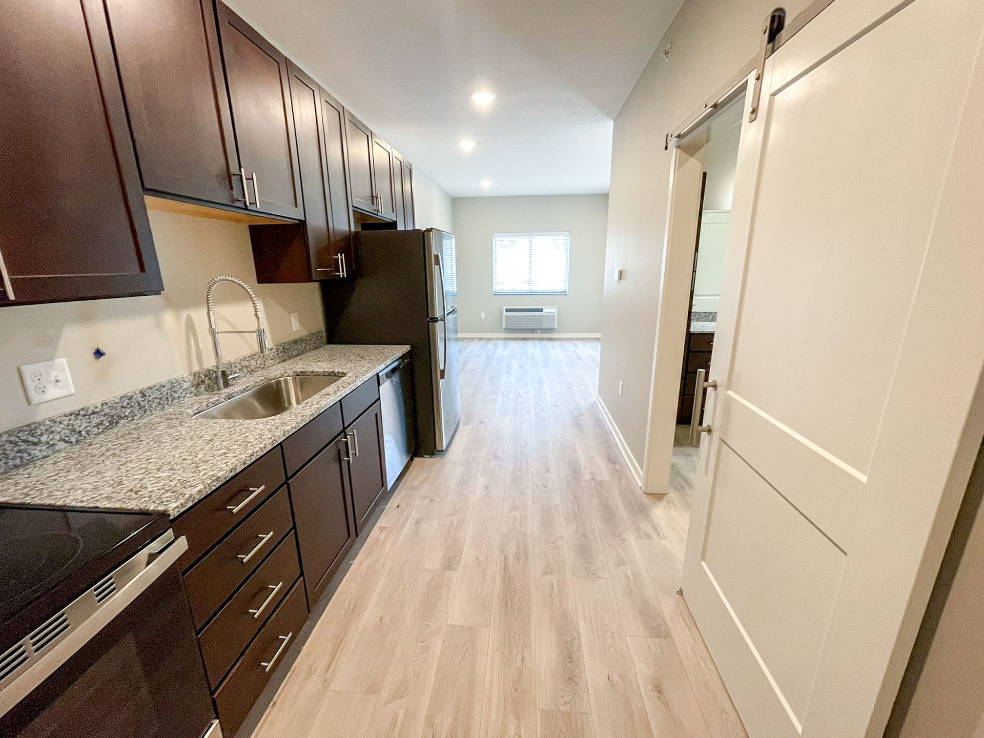 A kitchen with granite counter tops and stainless steel appliances