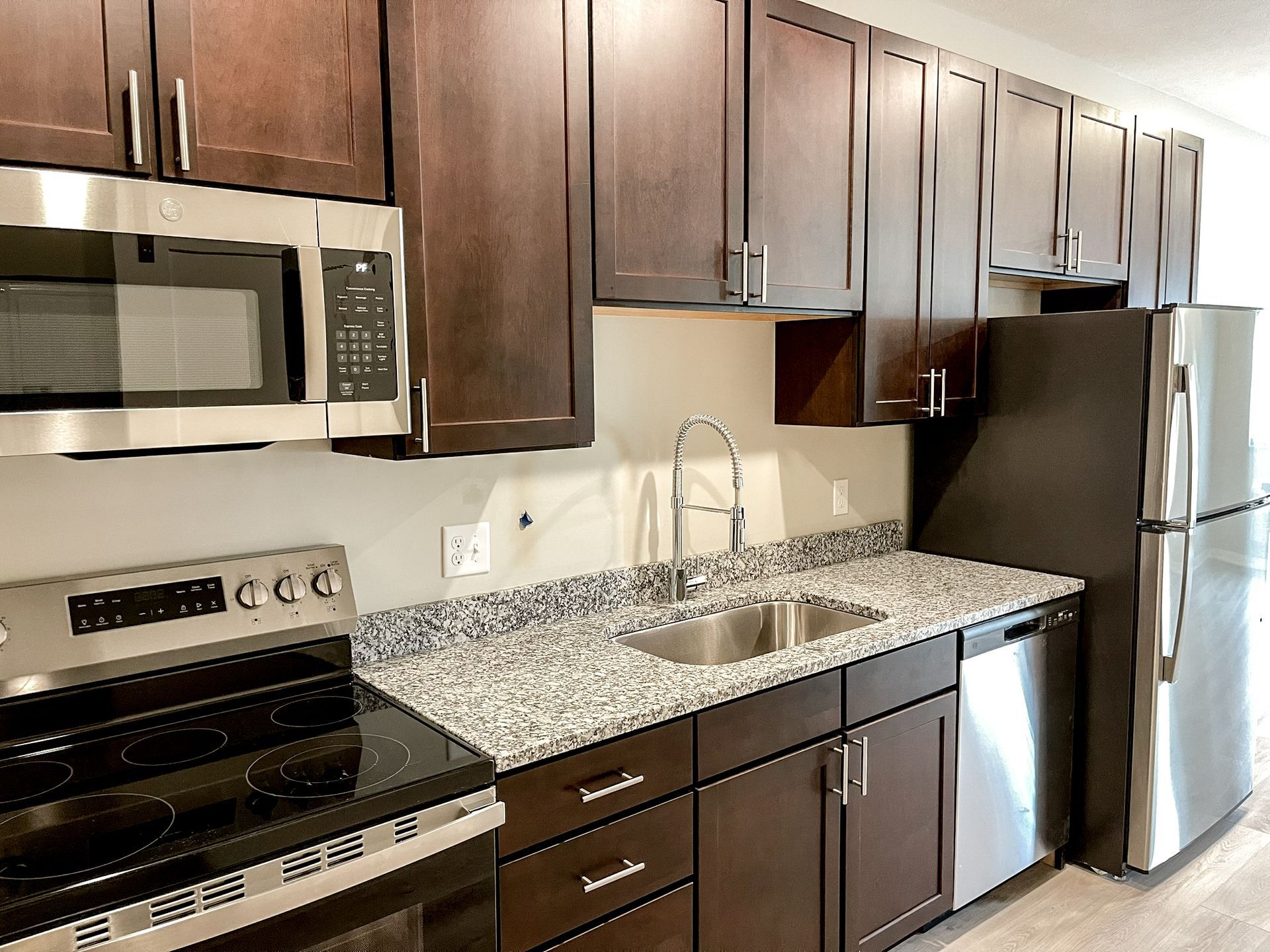 A kitchen with stainless steel appliances and granite counter tops