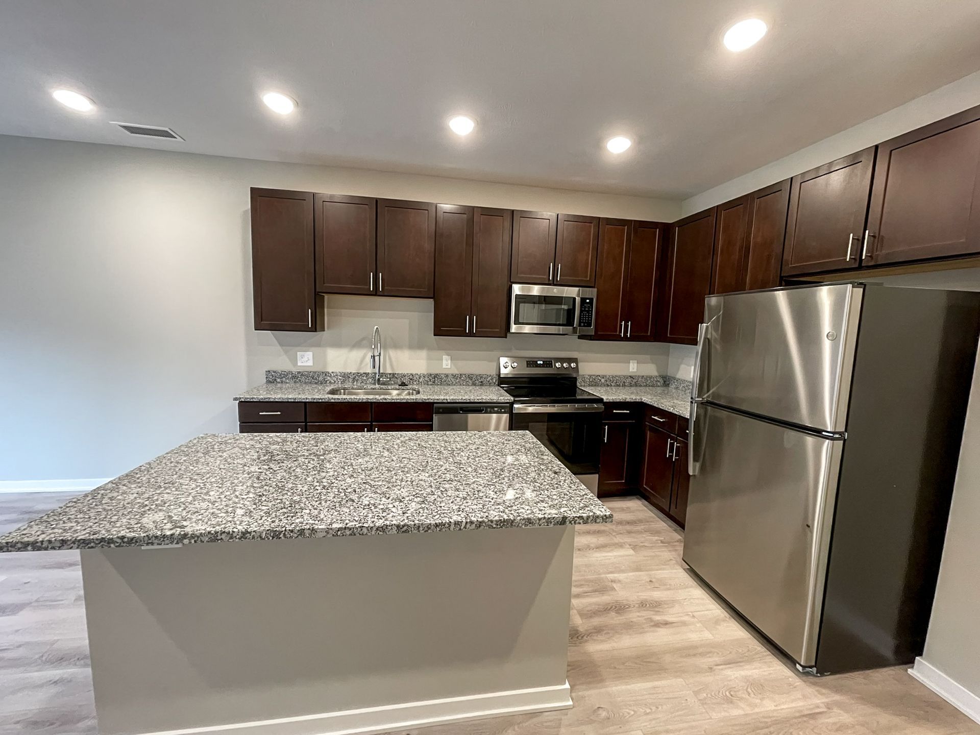 A kitchen with stainless steel appliances and granite counter tops