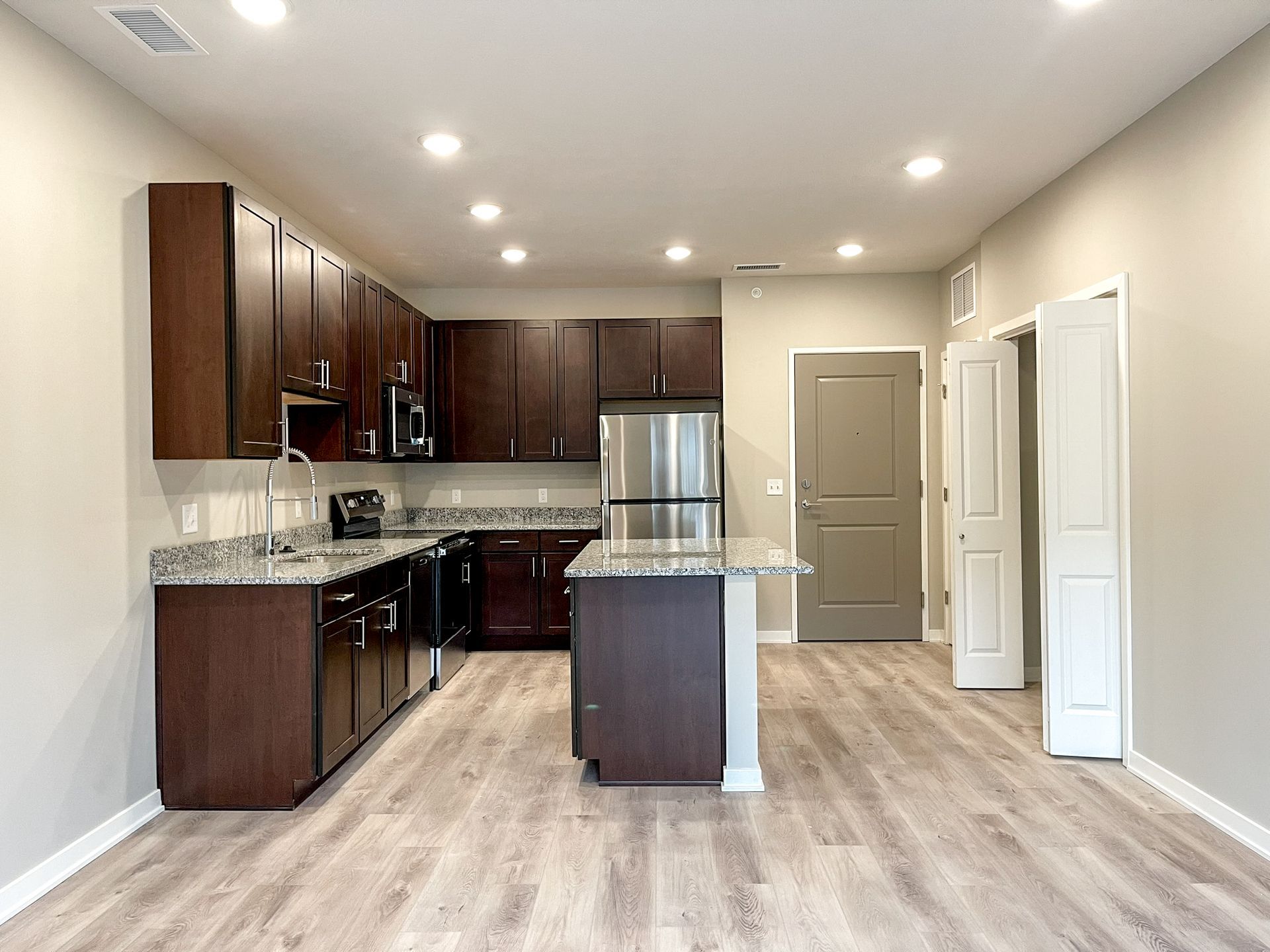 A kitchen with stainless steel appliances and wooden cabinets