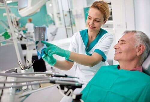 Dentist showing teeth problem on dental X-ray — Dental Service in North Tonawanda, NY
