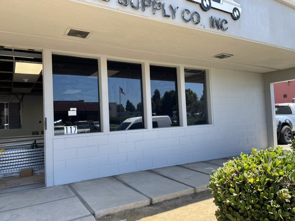 Exterior of a building with tinted windows, sign 