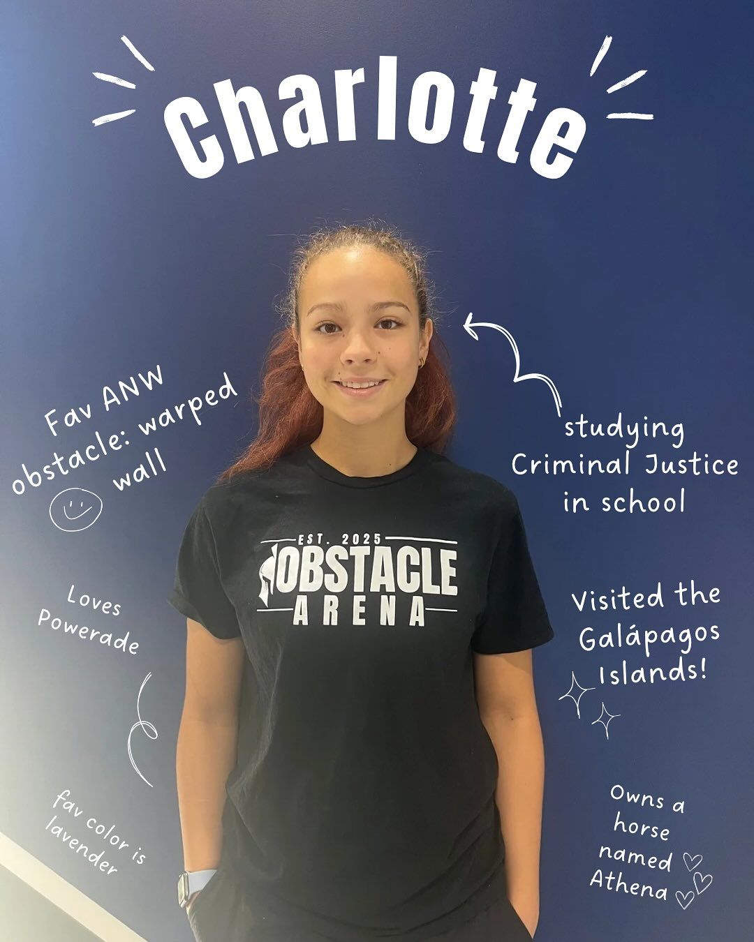 Woman in black shirt in front of a blue wall with text and doodles about her, including 