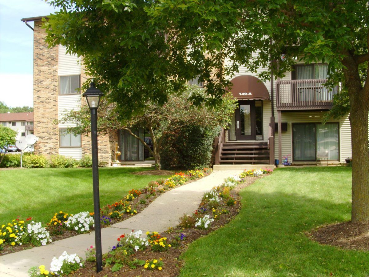 a large apartment building with a walkway leading to it