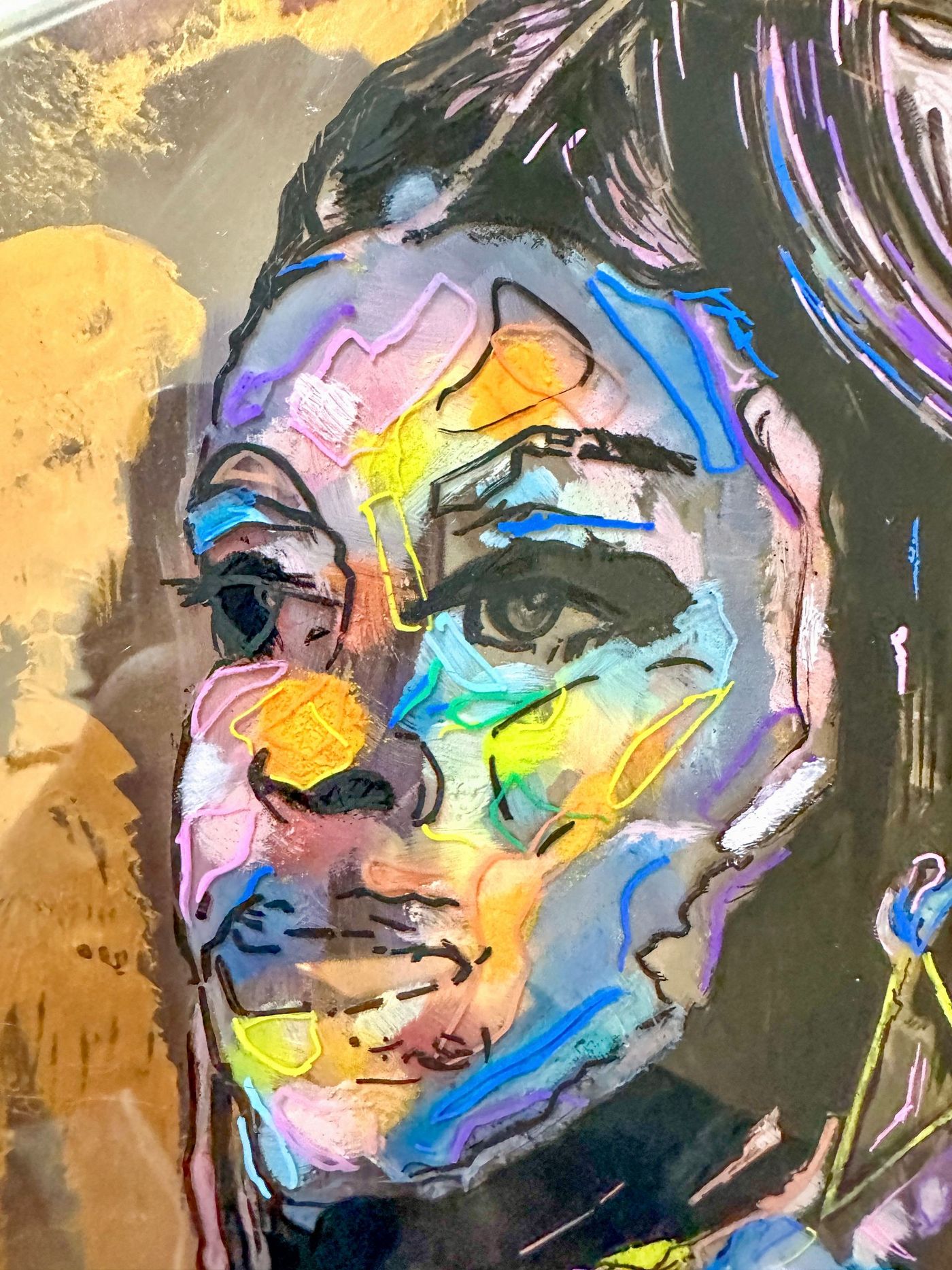 A close up of a colorful painting of a woman 's face.