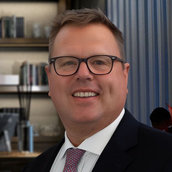 Laptop and tablet displaying financial charts on a wooden table.