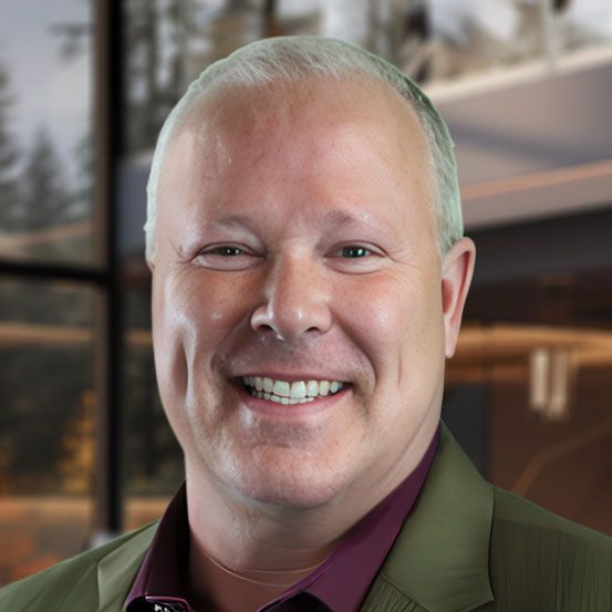Laptop and tablet displaying financial charts on a wooden table.