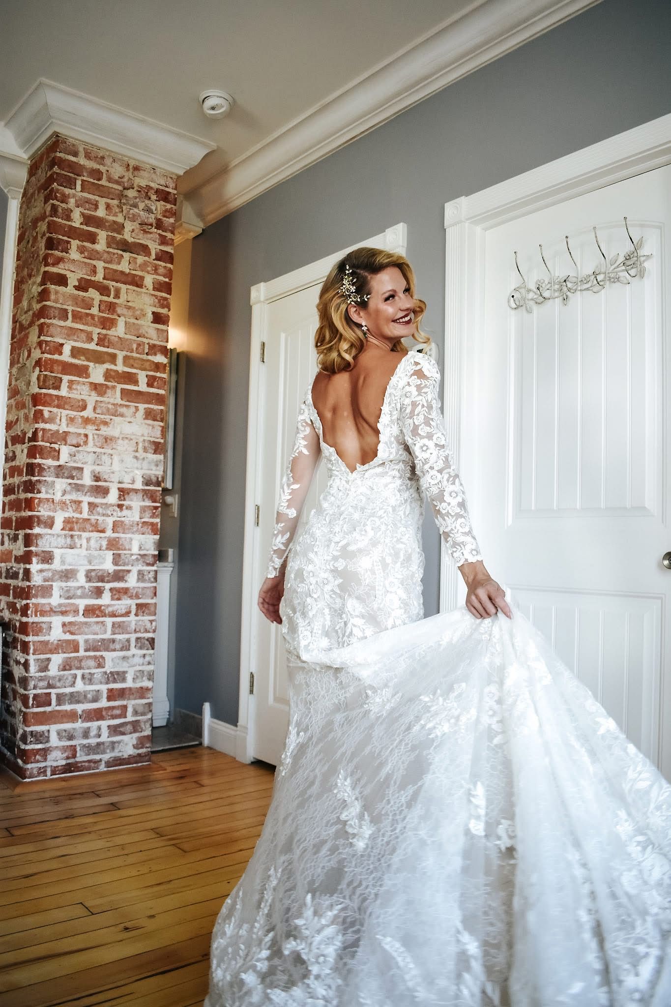 A woman in a wedding dress is standing in front of a door.