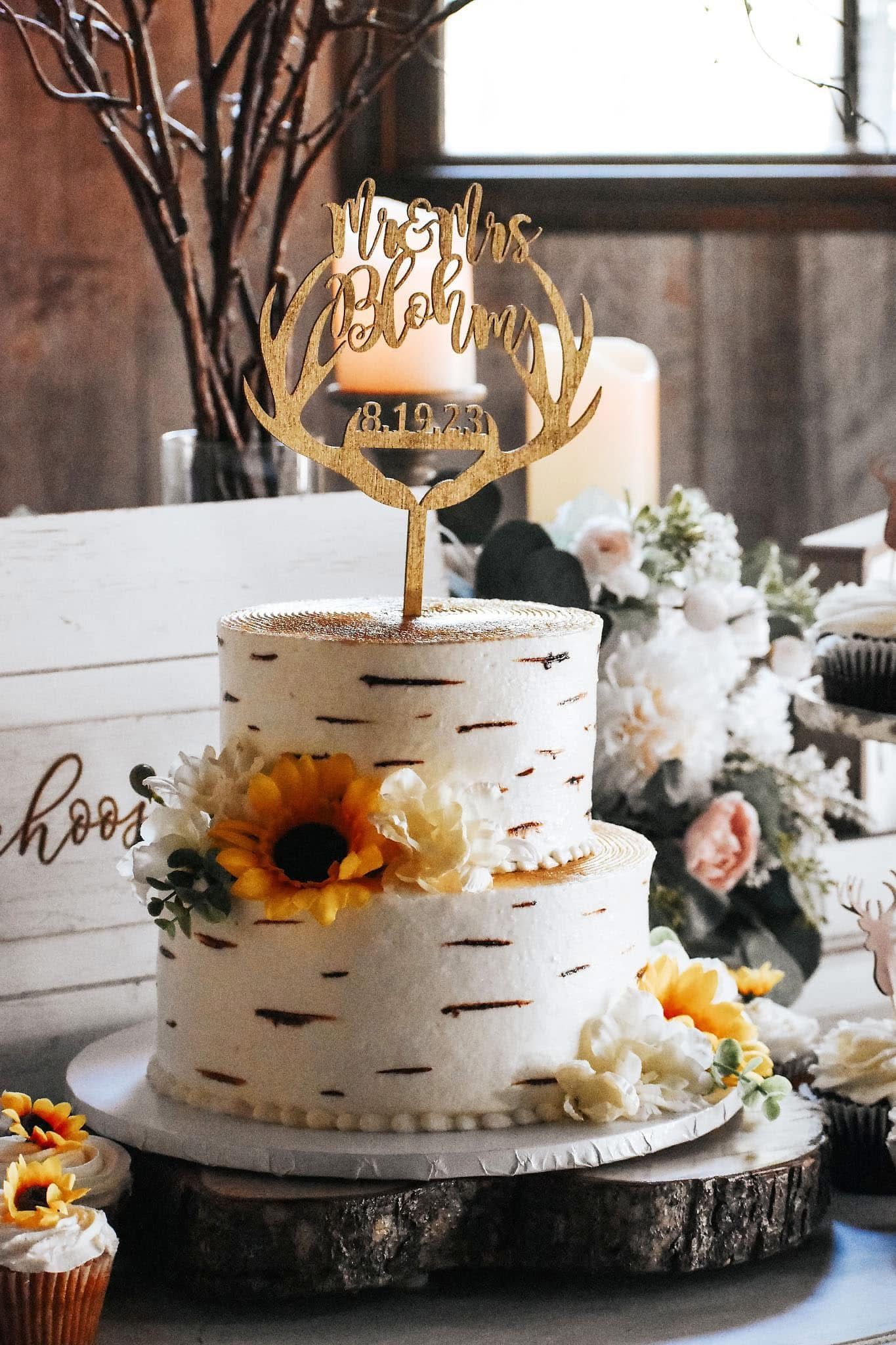 A wedding cake with a sunflower on top of it