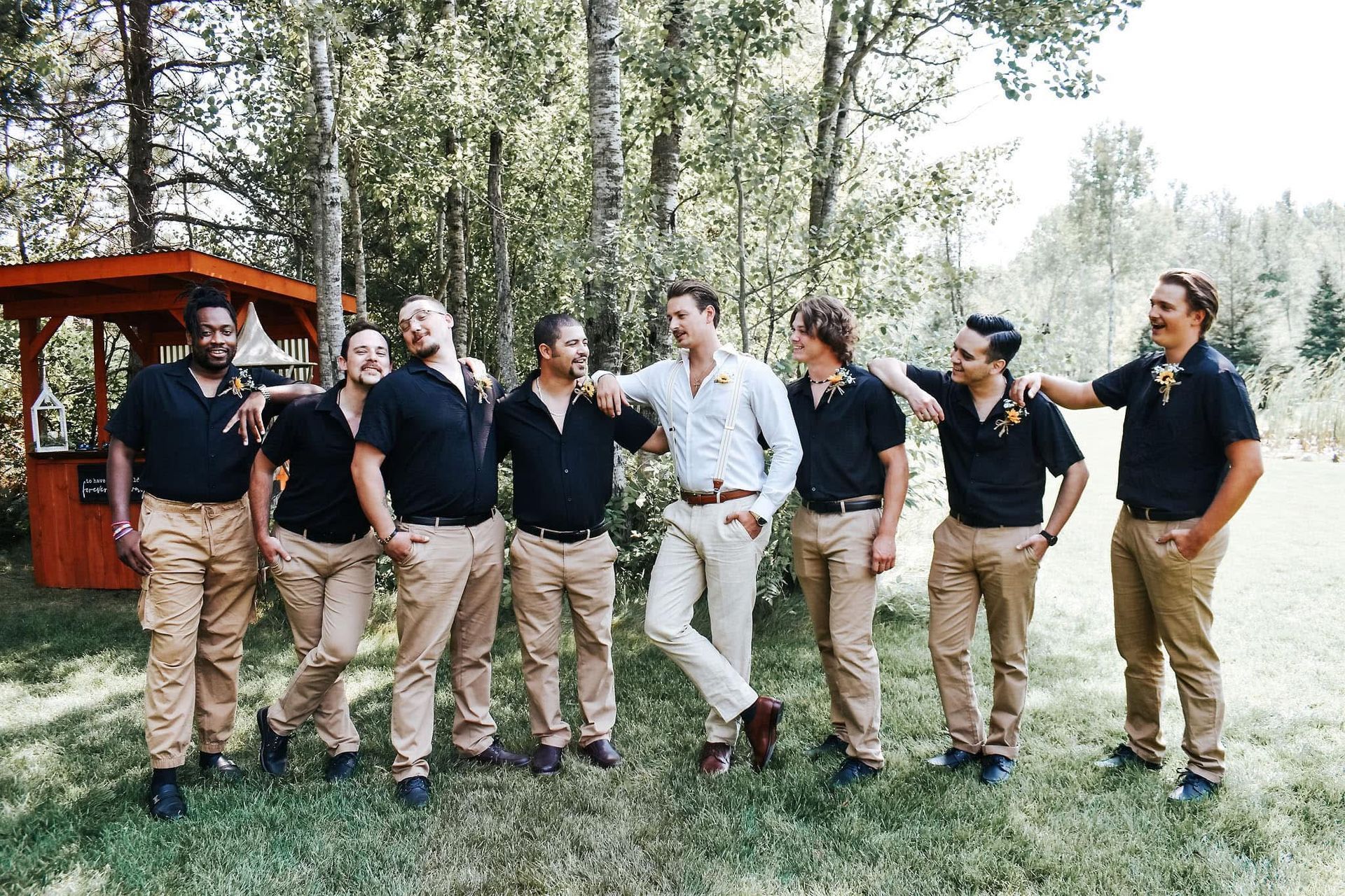 A group of men are standing next to each other in a field.