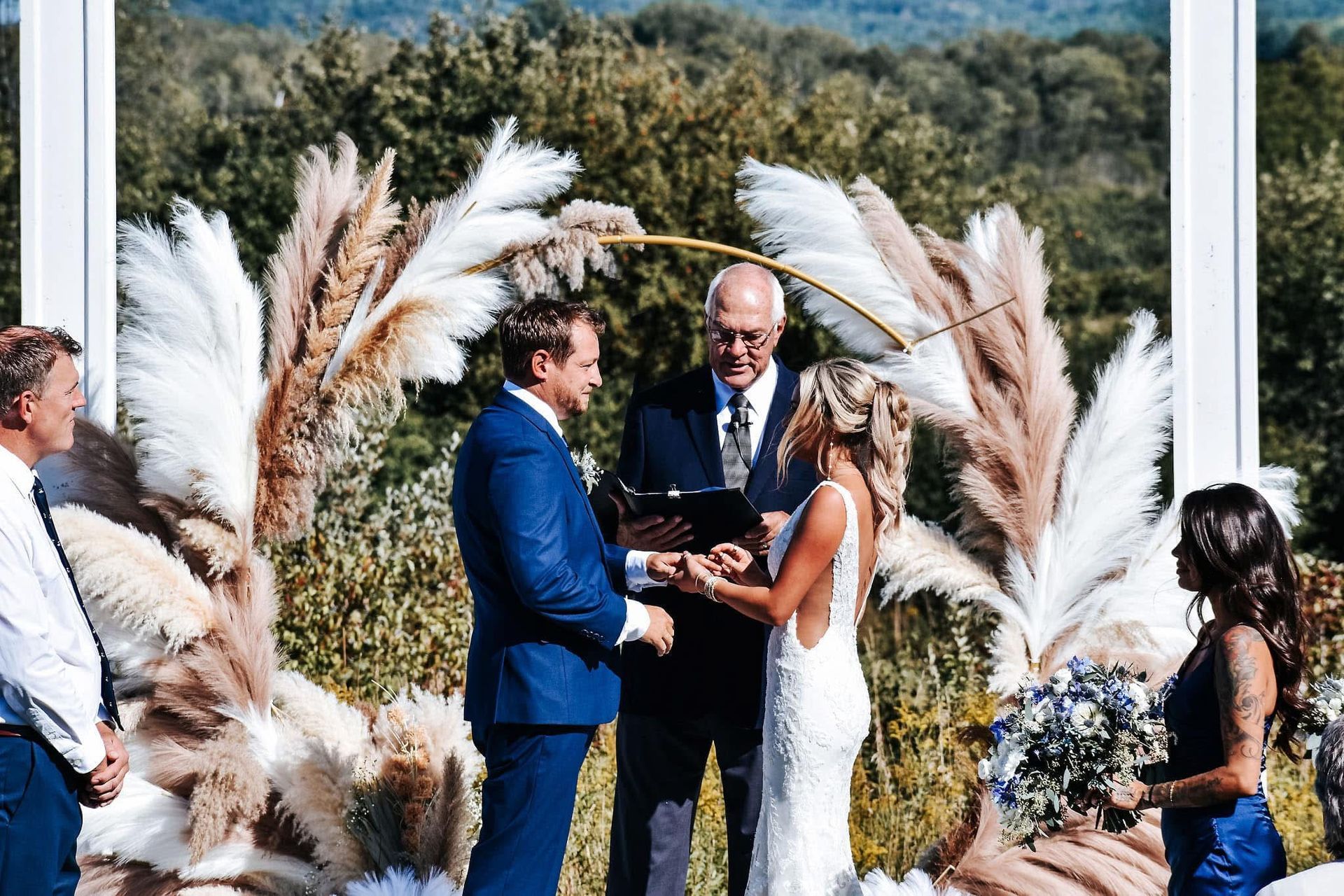 A bride and groom are holding hands during their wedding ceremony.